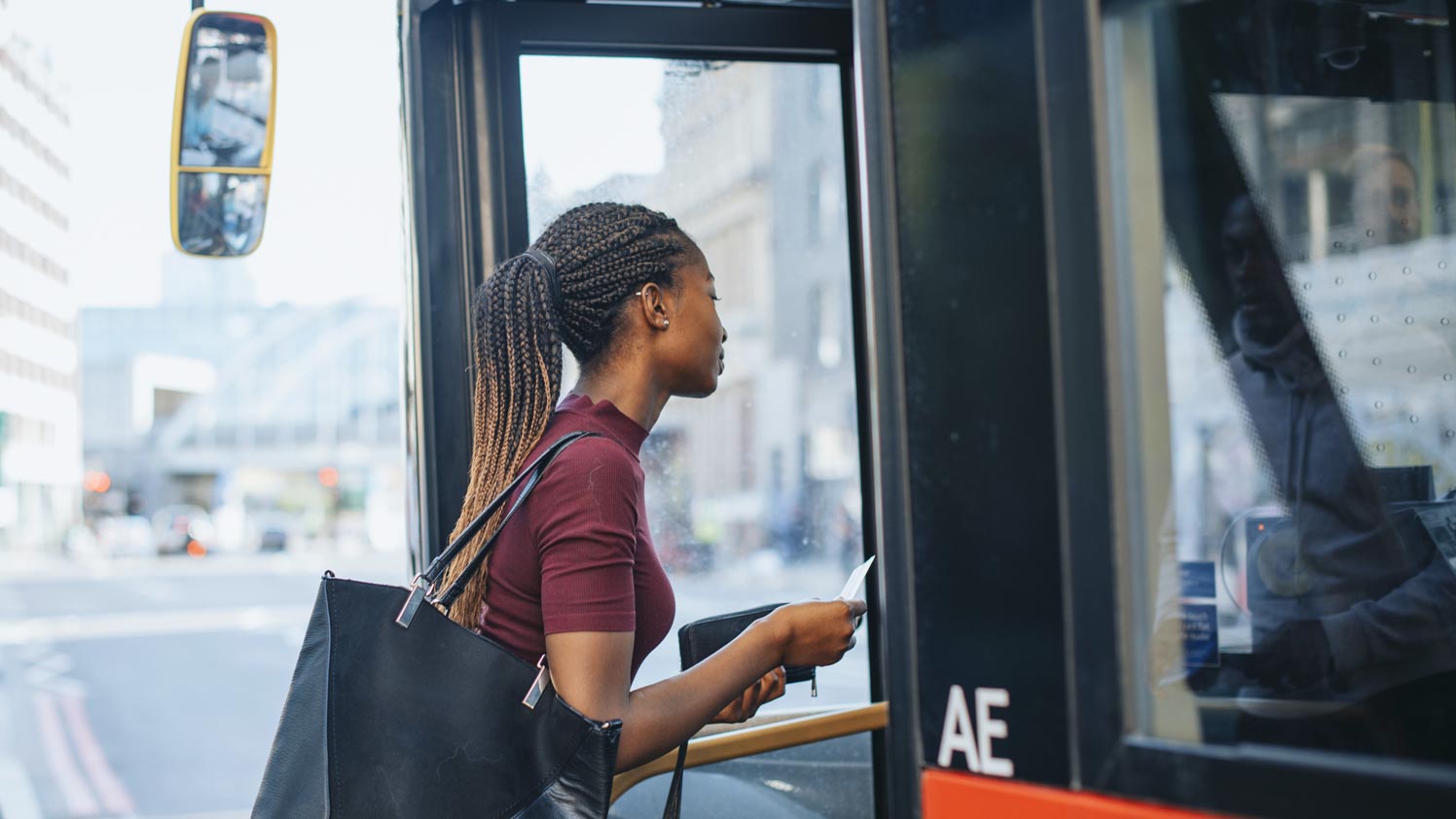 Woman walking onto a bus