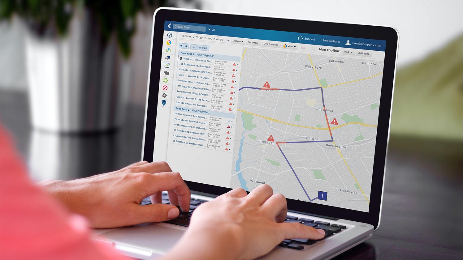 Woman navigating MyGeotab dashboard on a computer monitor