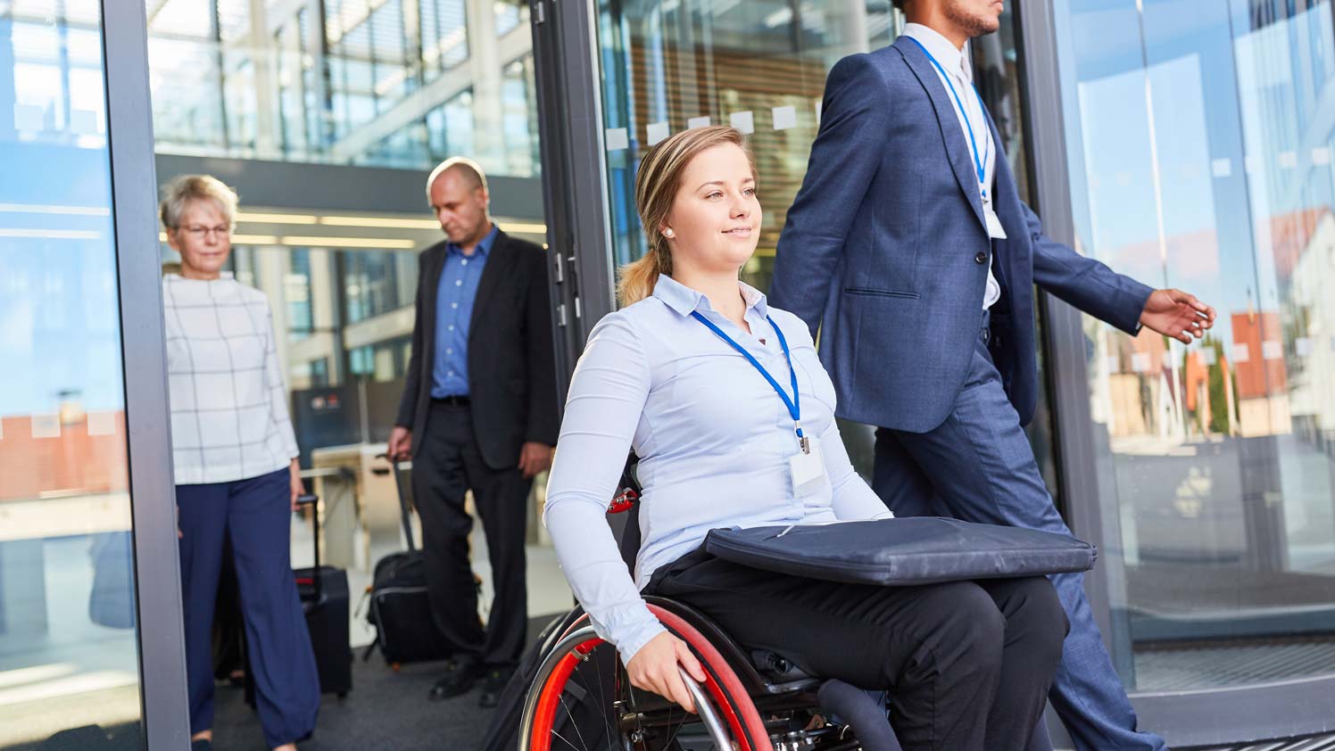 Woman on a wheelchair exiting a building