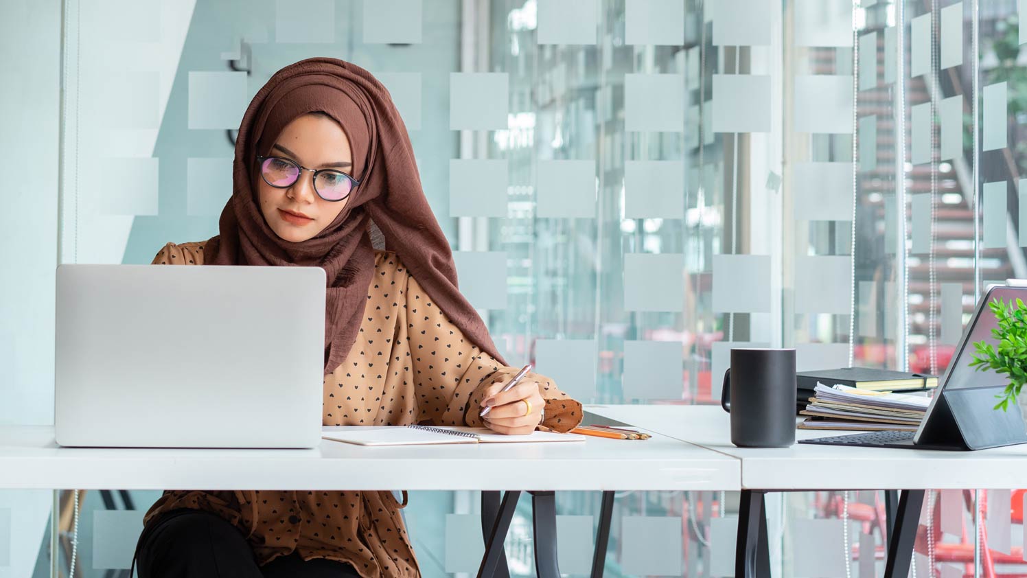 Woman using laptop at desk