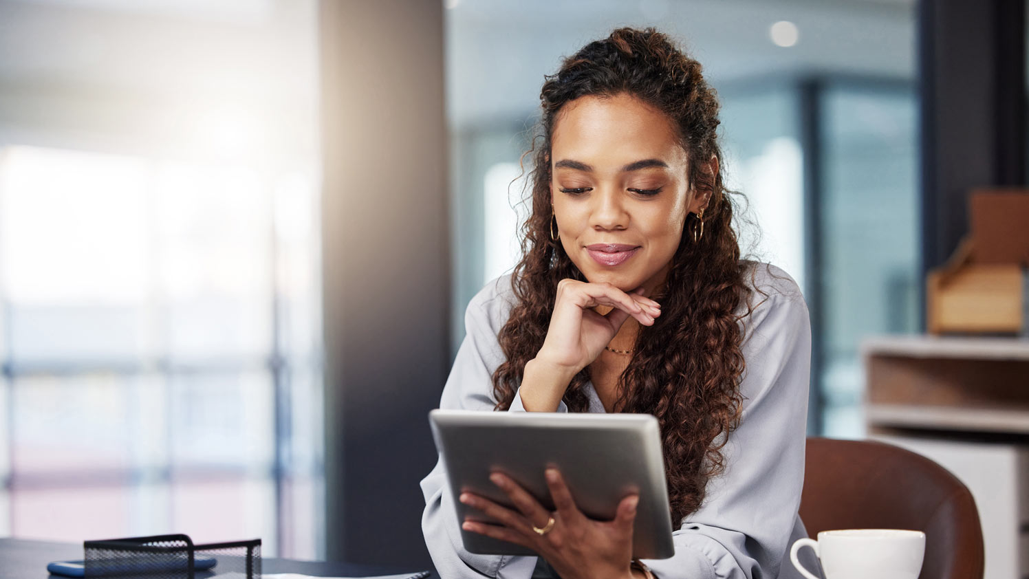 Woman smiling while using tablet