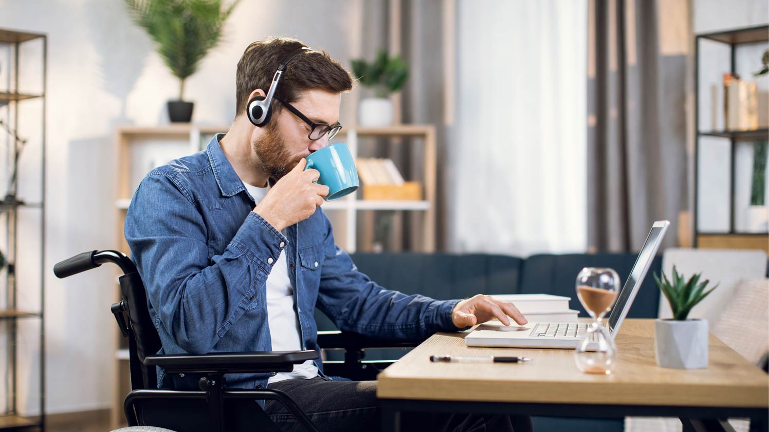 Man using laptop while sipping coffee