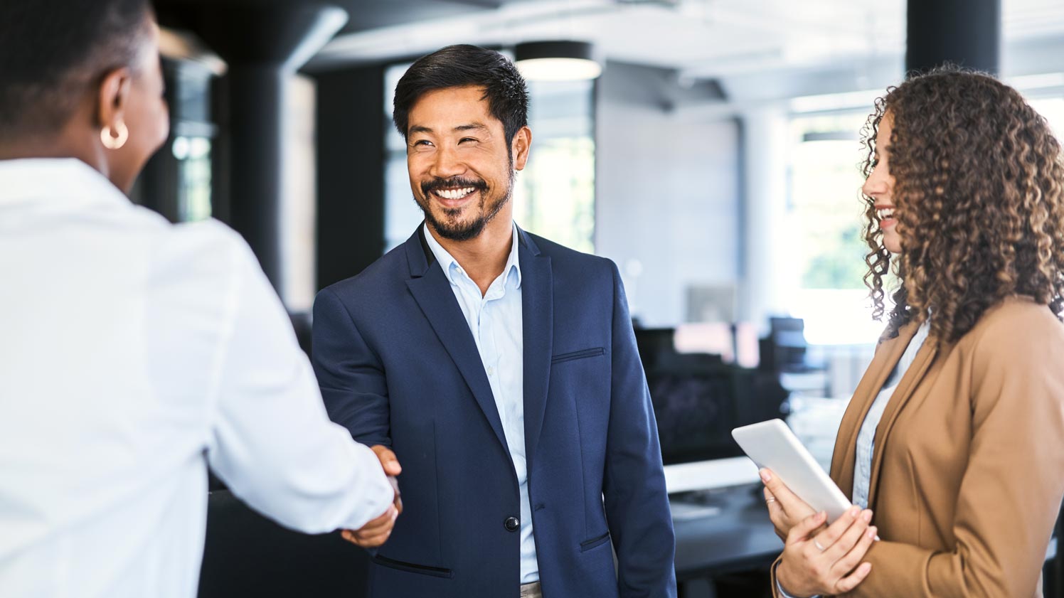 Man shaking woman's hands