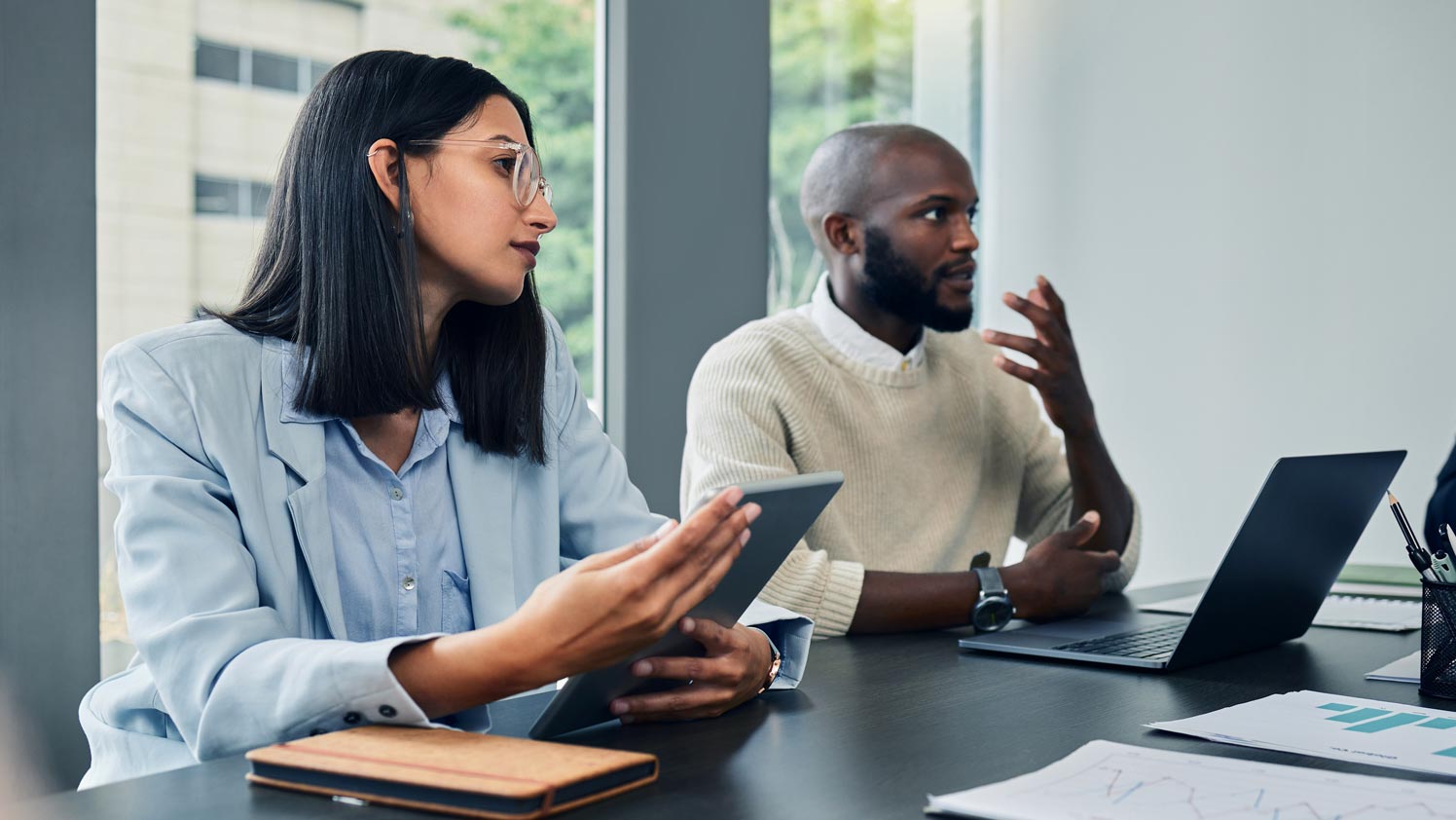 Man and woman at a meeting room table