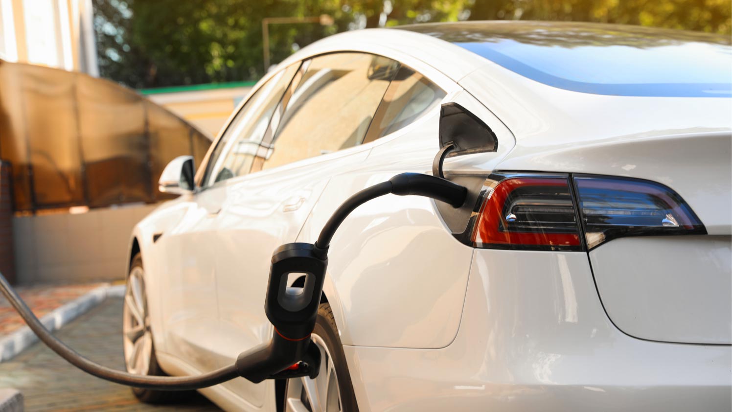 A white EV plugged in