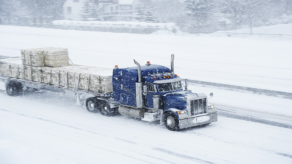 A truck driving through a blizzard 