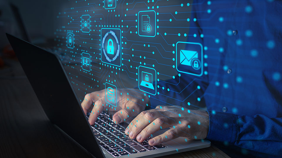 Person using a laptop with security icons