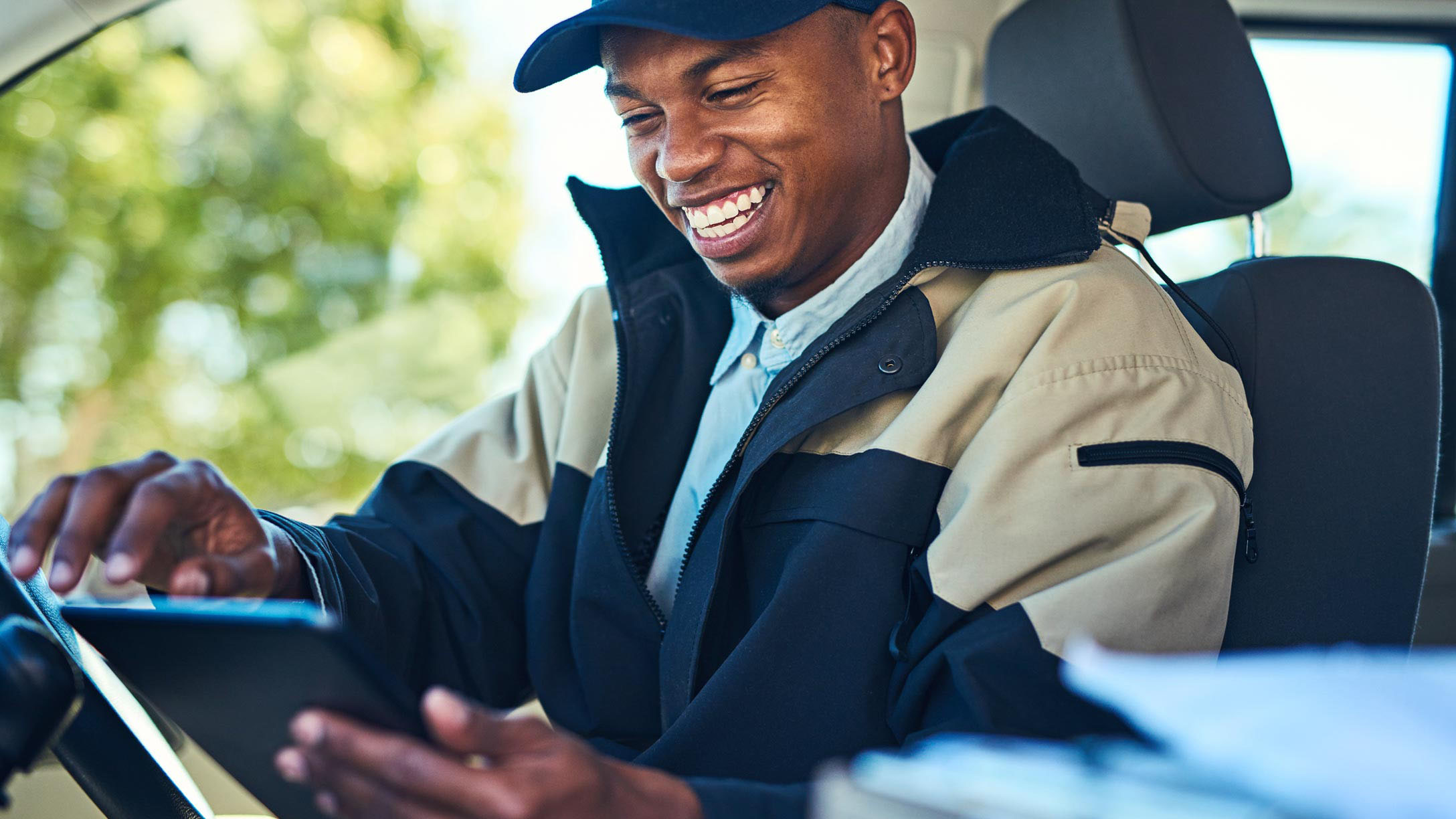 Smiling male driver holding an ELD tablet