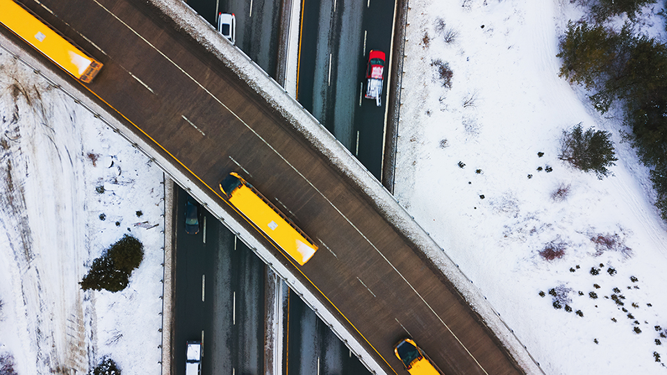 A fleet of trucks on the highway during winter 