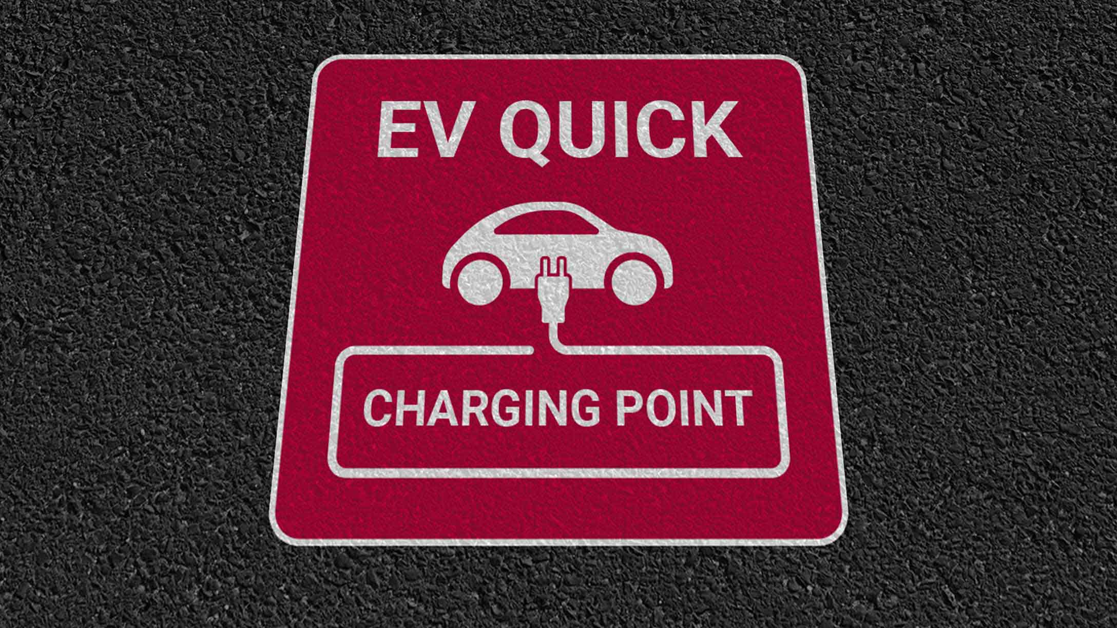 Red sign that says 'EV QUICK Charing Point' with electric vehicle icon