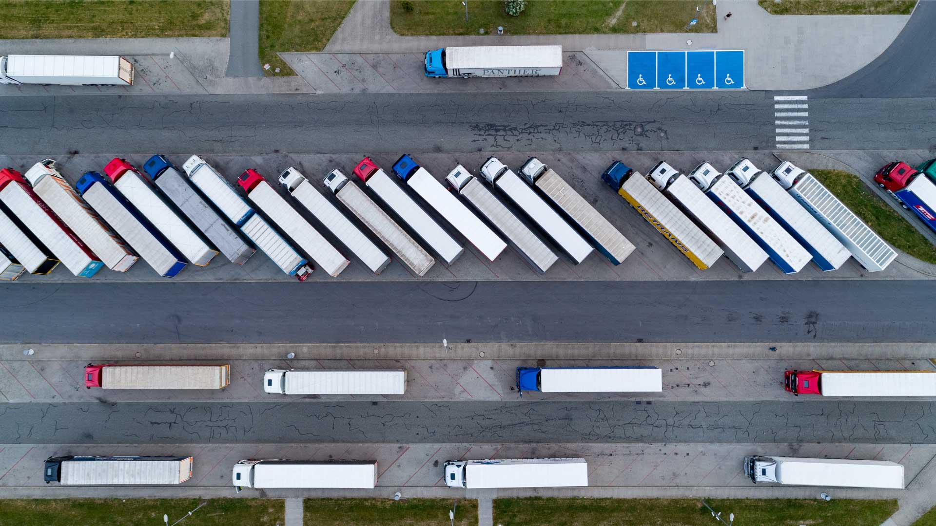 A picture of trucks parked in a parking spot.