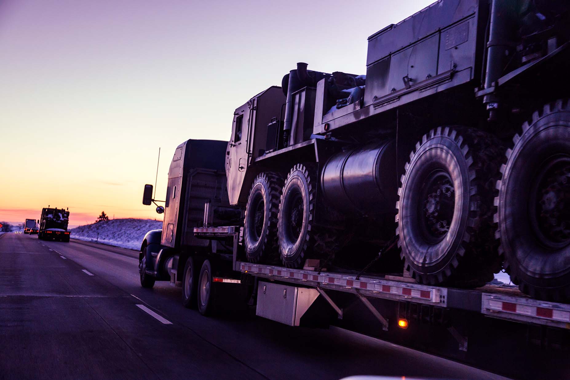 A truck carrying heavy equipment.
