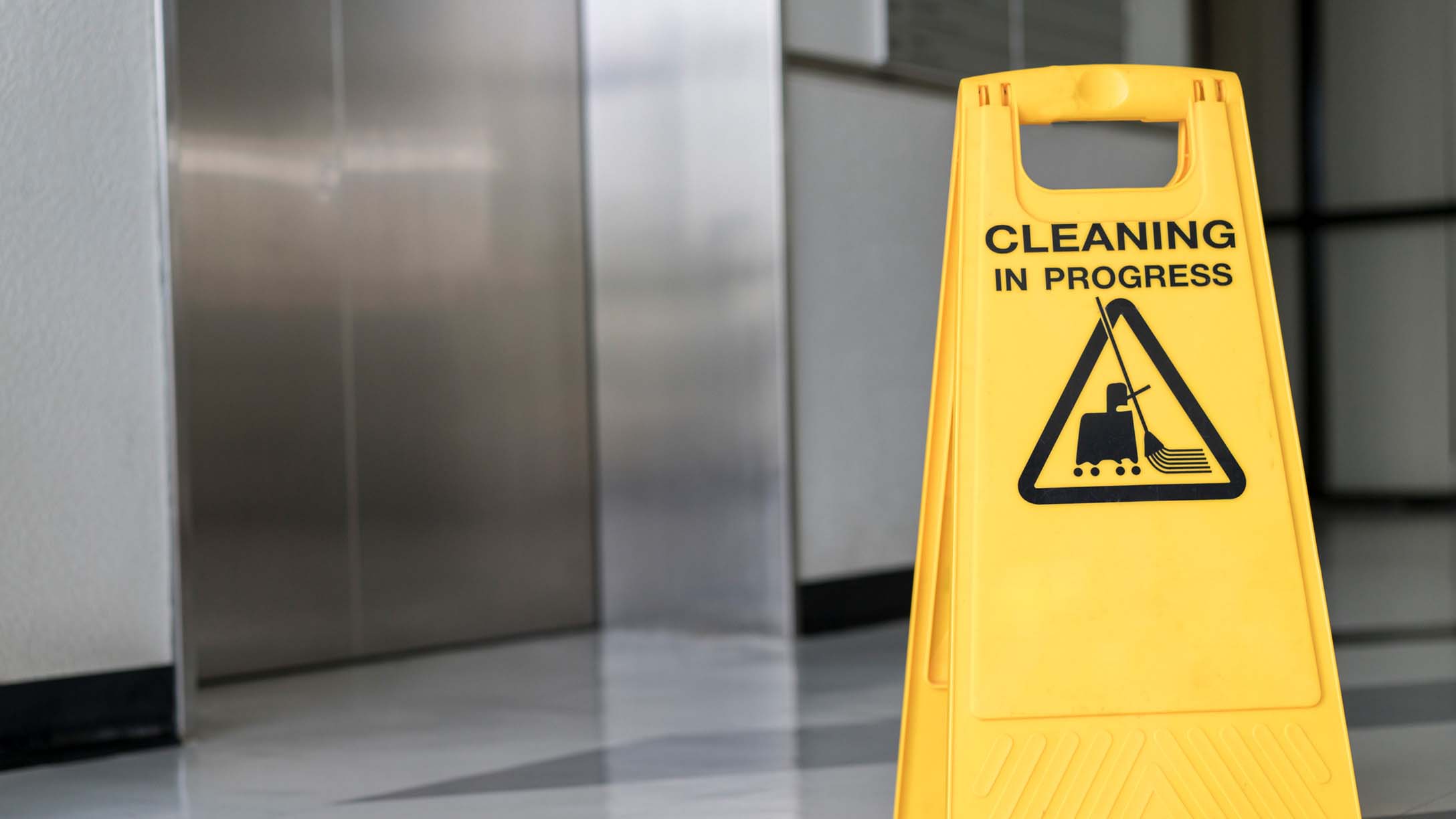 Image of a wet floor sign with "cleaning in progress" on it