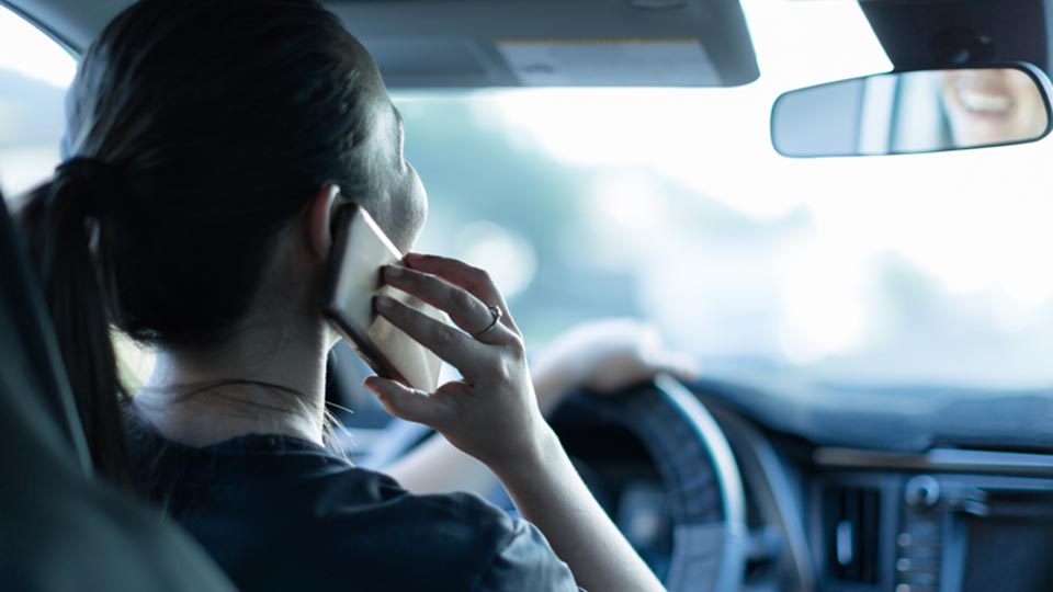 Woman distracted driving on her cell phone