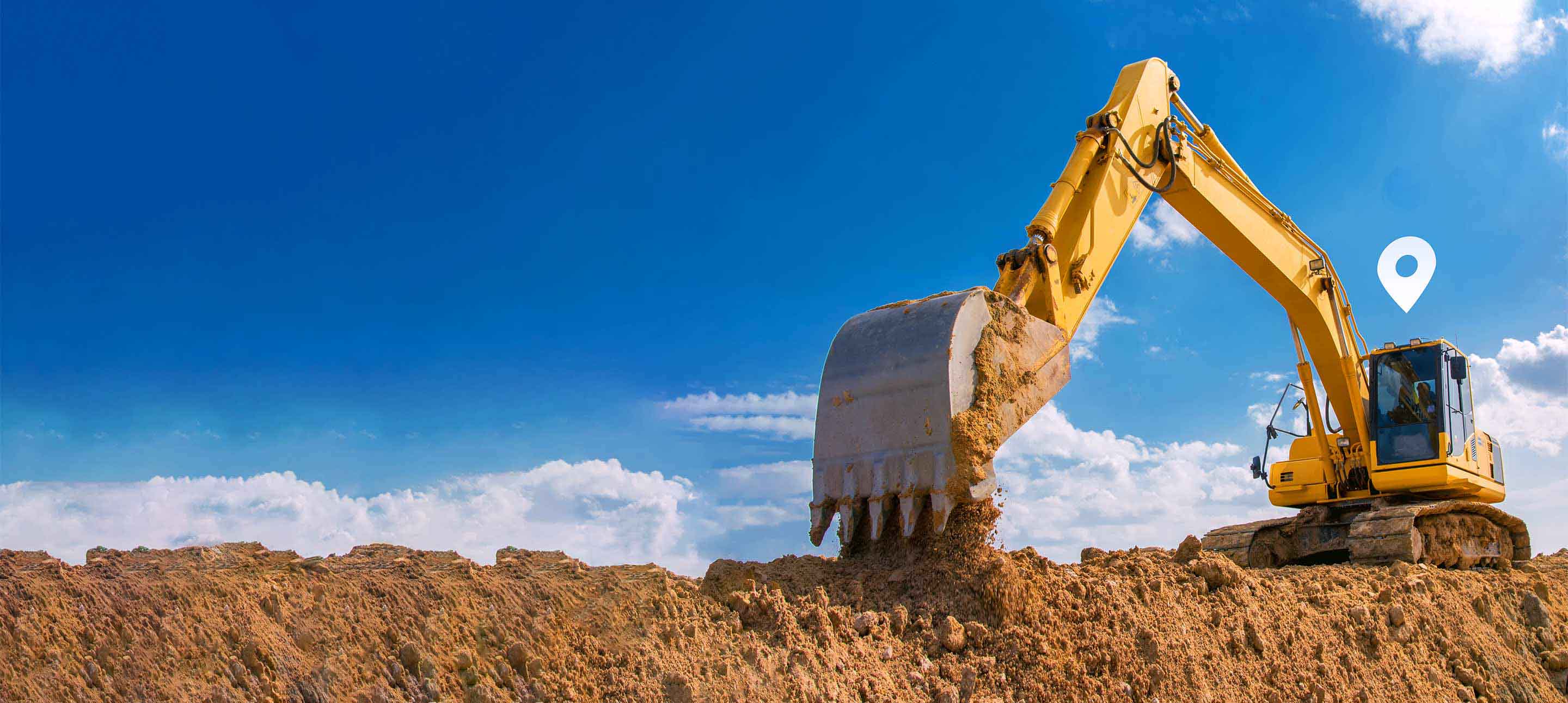 Yellow excavator picking up dirt being tracked using Geotab software