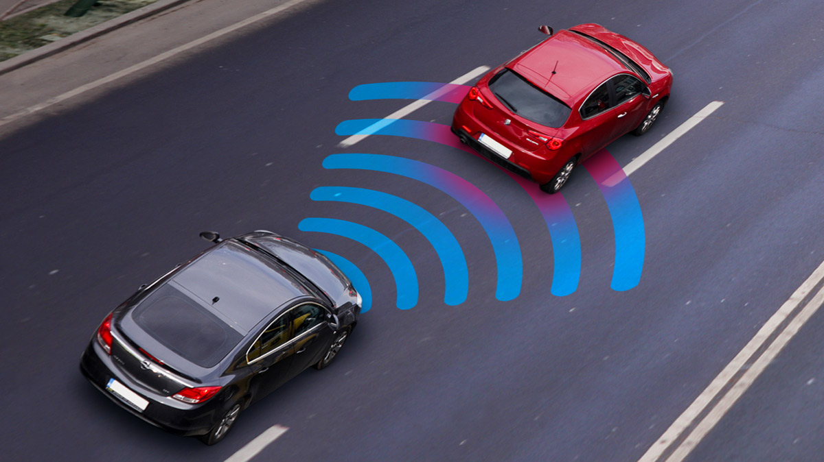 Two cars driving on a road with graphic display of sensor alerting the driver to stay back