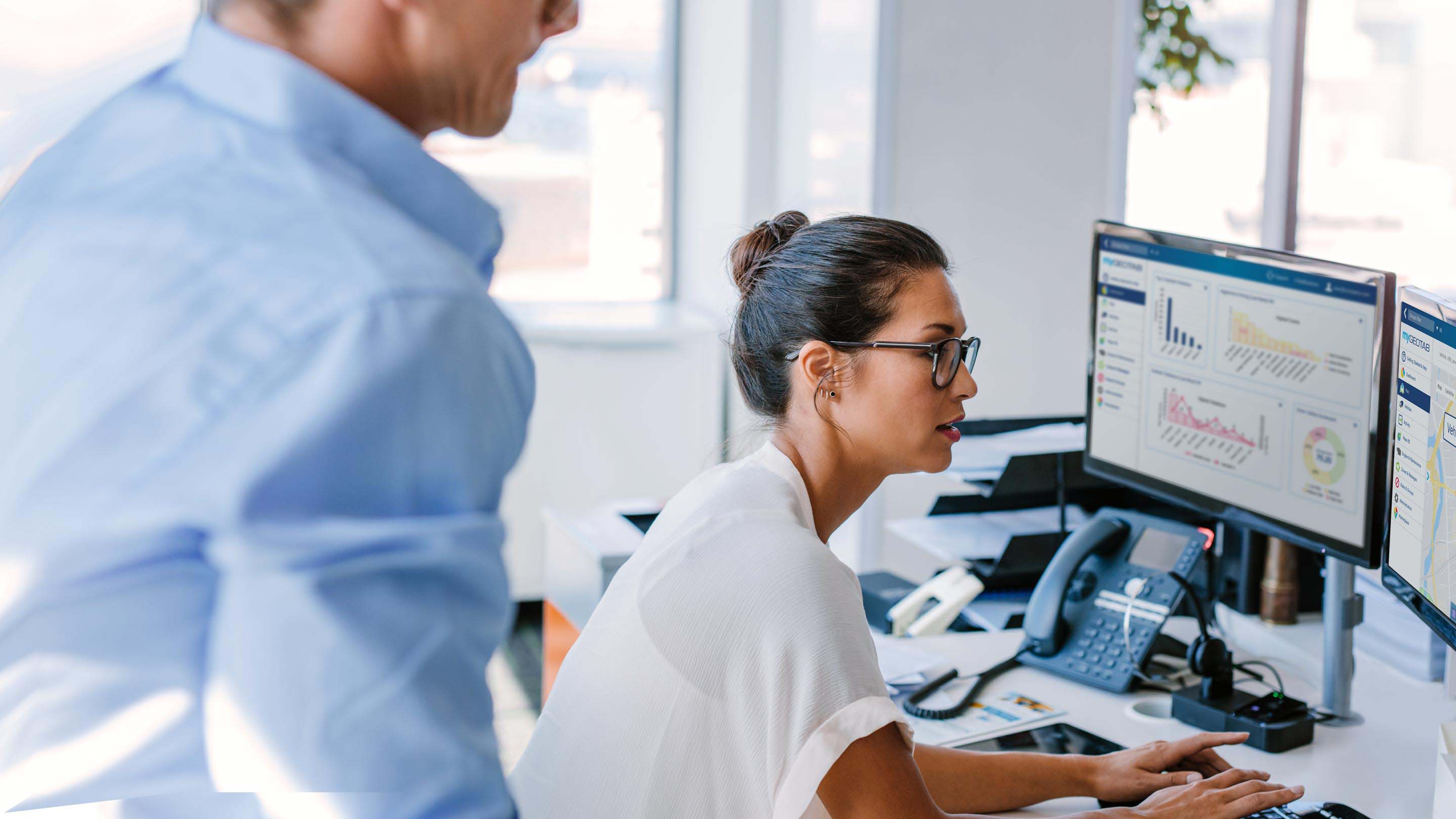 Man and woman using MyGeotab Interface