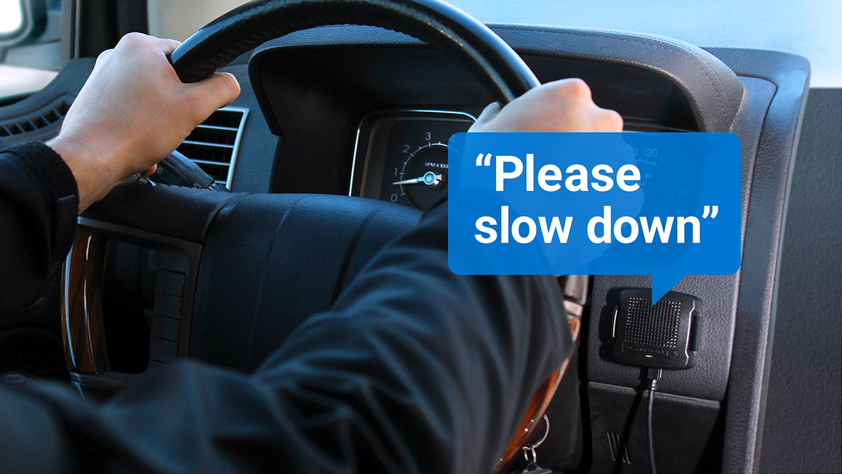 Geotab GO TALK driver feedback GO TALK reminding driver to slow down in a blue speech bubble.