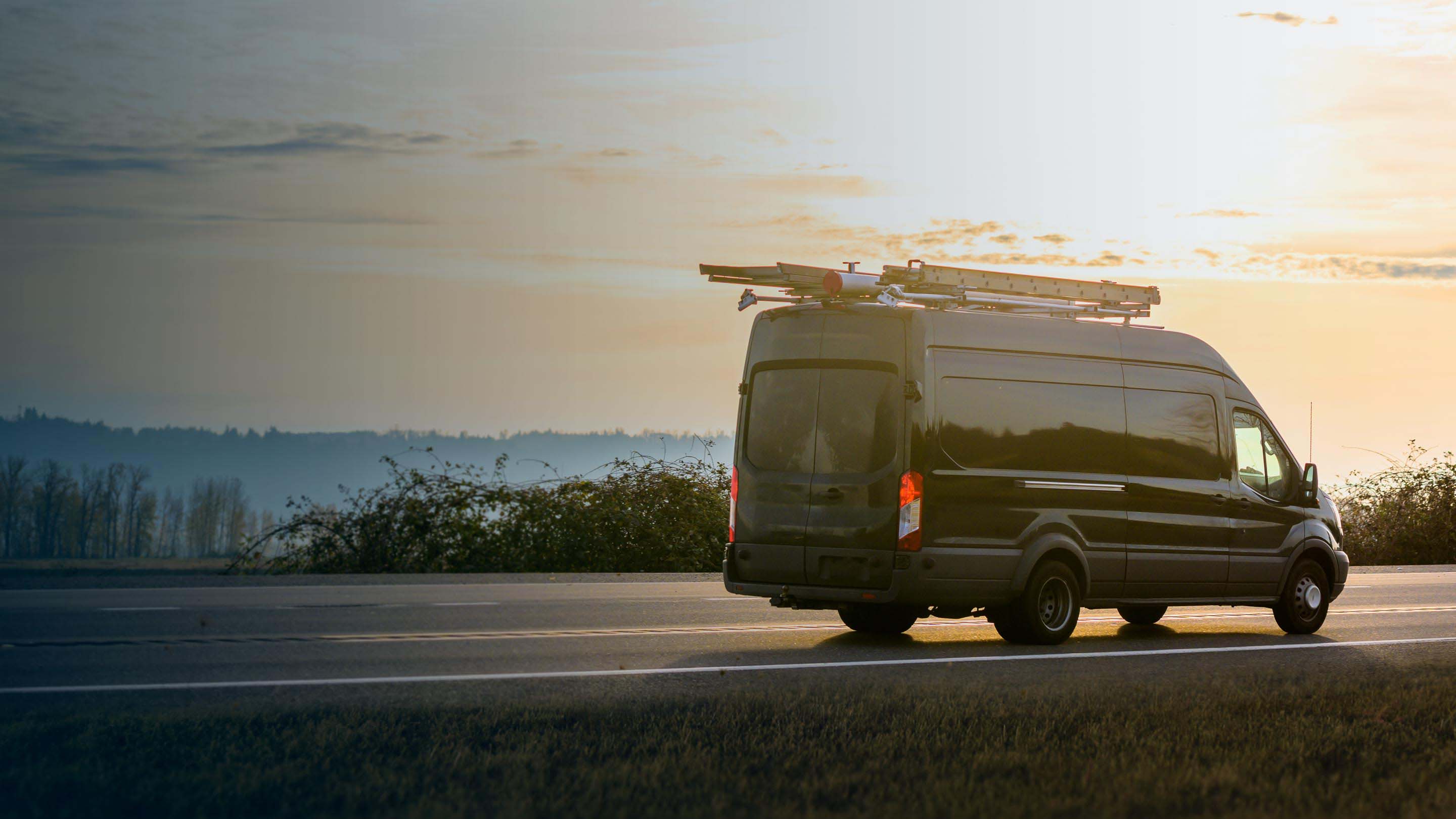 Grey van driving on road