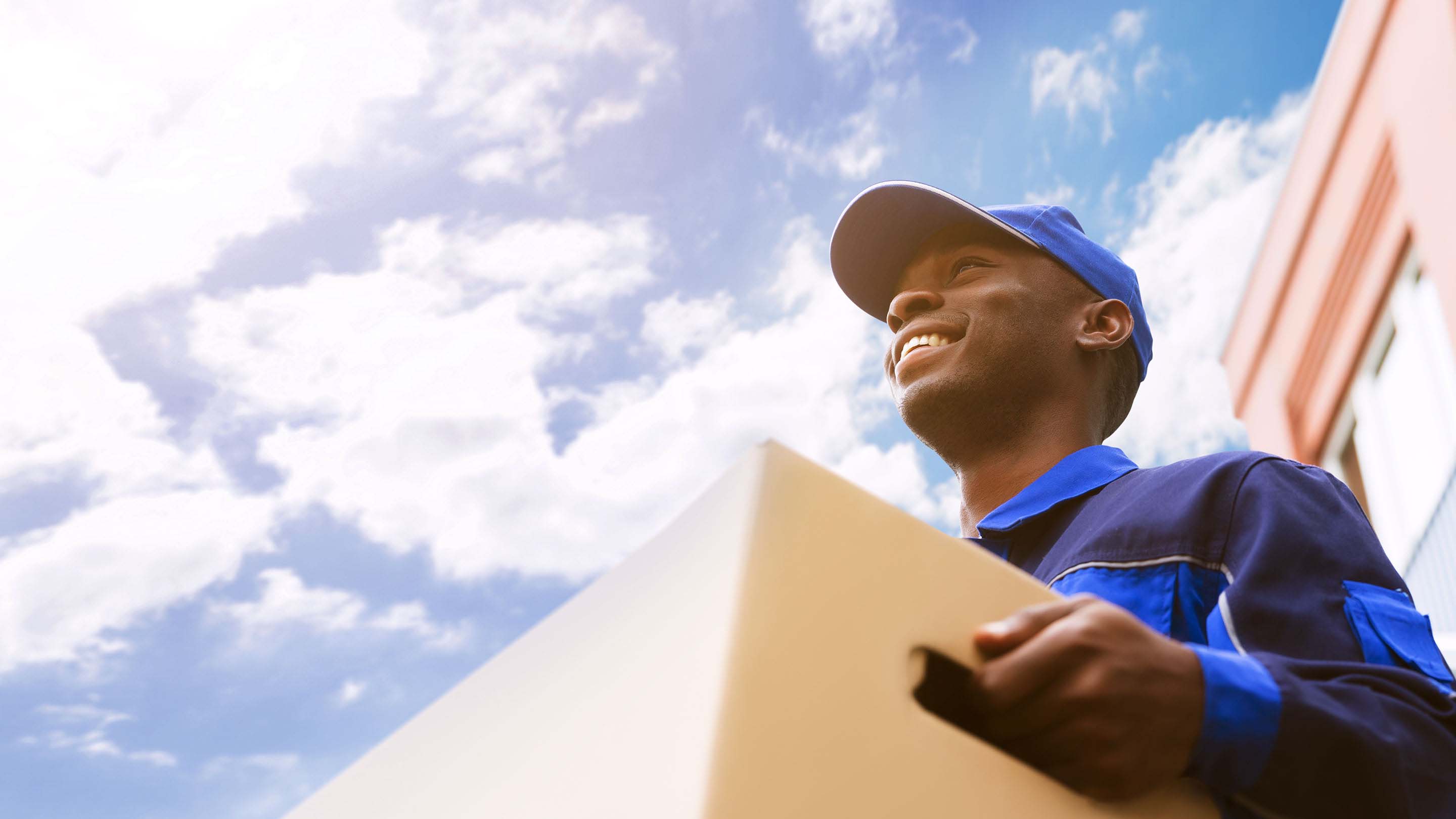 Delivery person with hat delivering a box