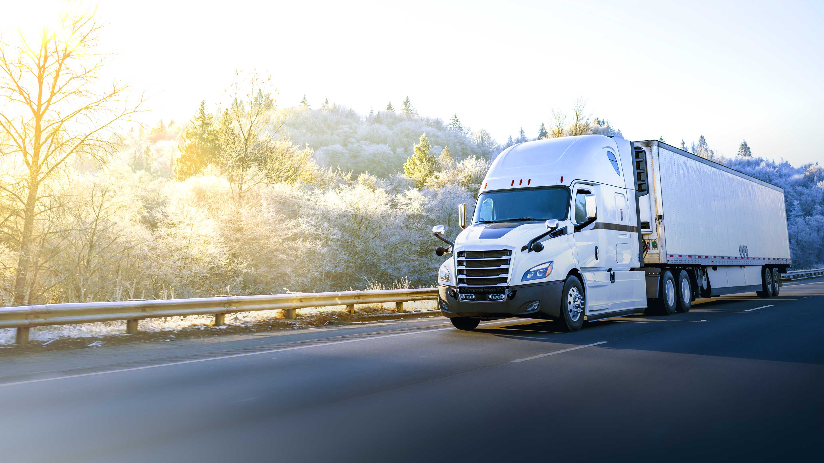 White truck driving on a road
