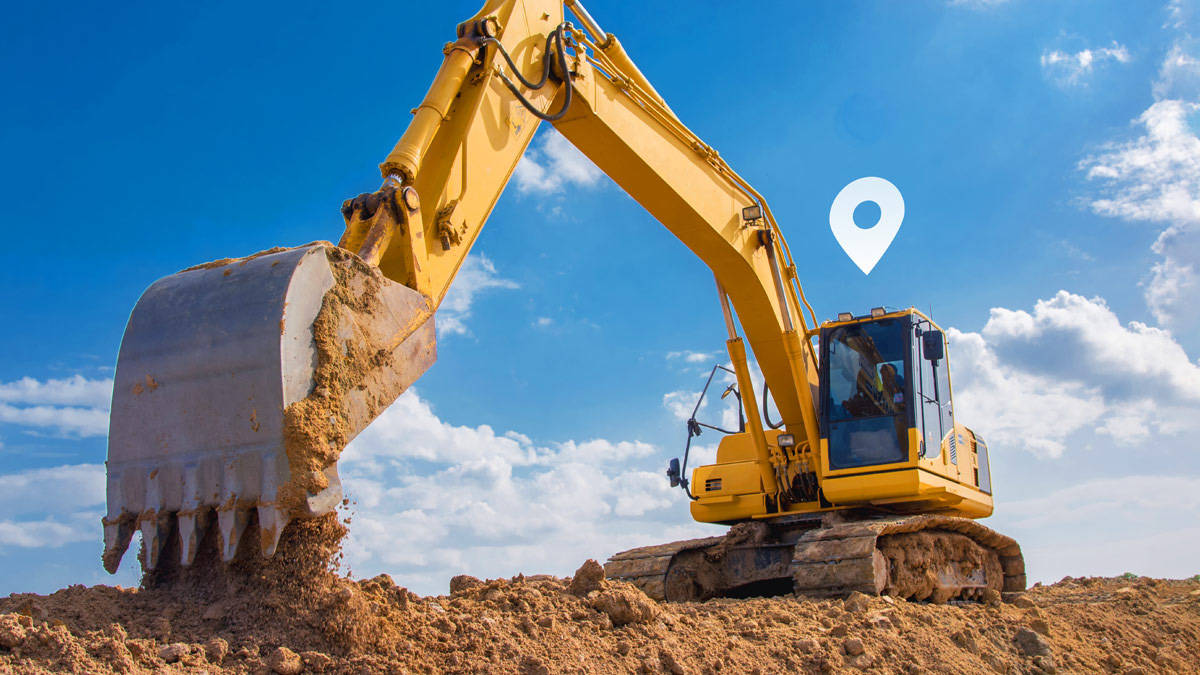 Vehículo de construcción amarillo grande cavando en la tierra con un símbolo de GPS blanco encima 