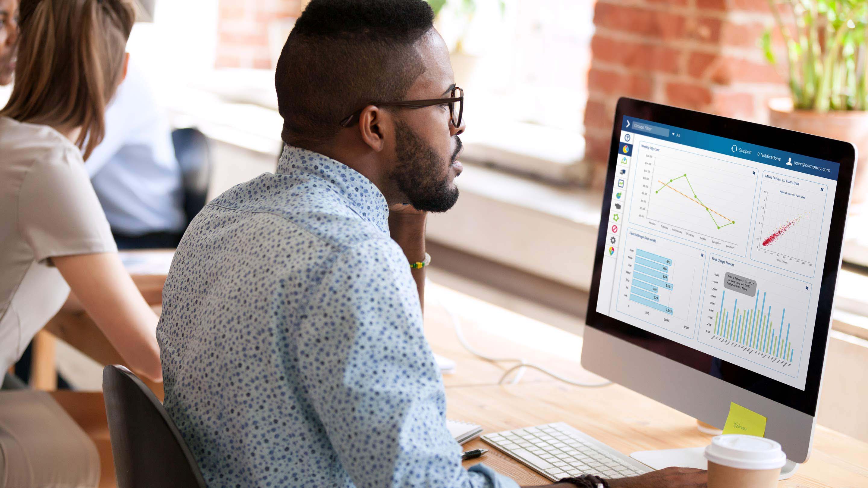 Man using MyGeotab interface on desktop computer