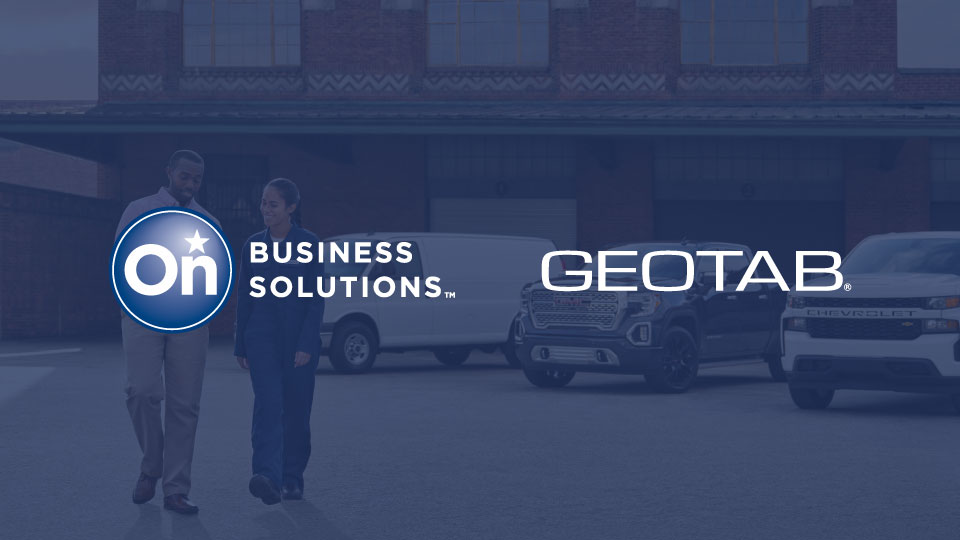 A photo of two people walking and talking in a parking lot with a dark blue overlay and the  General Motor's OnStar logo and Geotab's logo positioned side-by-side