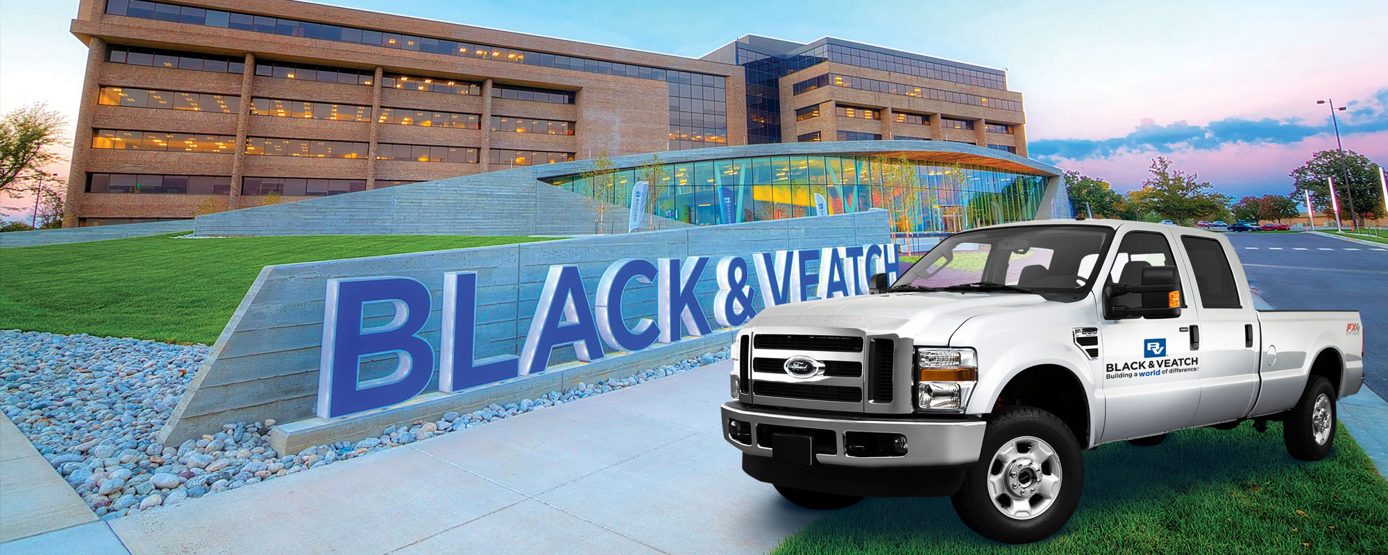 Grey vehicle in front of Black & Veatch sign