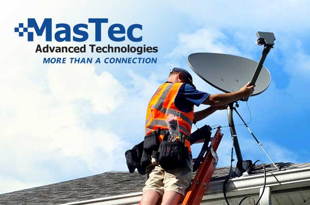 Man wearing an orange safety vest on a roof installing a satellite dish with the MasTec logo in the left hand corner.