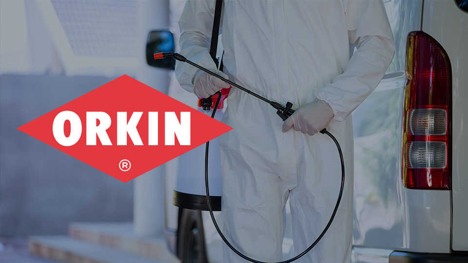 ORKIN logo beside person in white coat