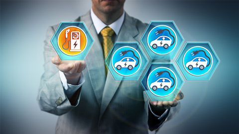 Man in suit holding electric vehicle icons