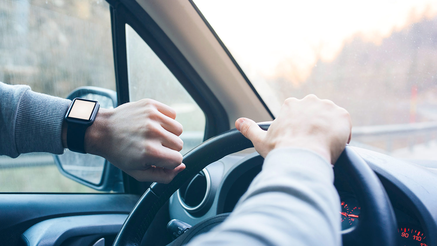man checking watch while driving truck