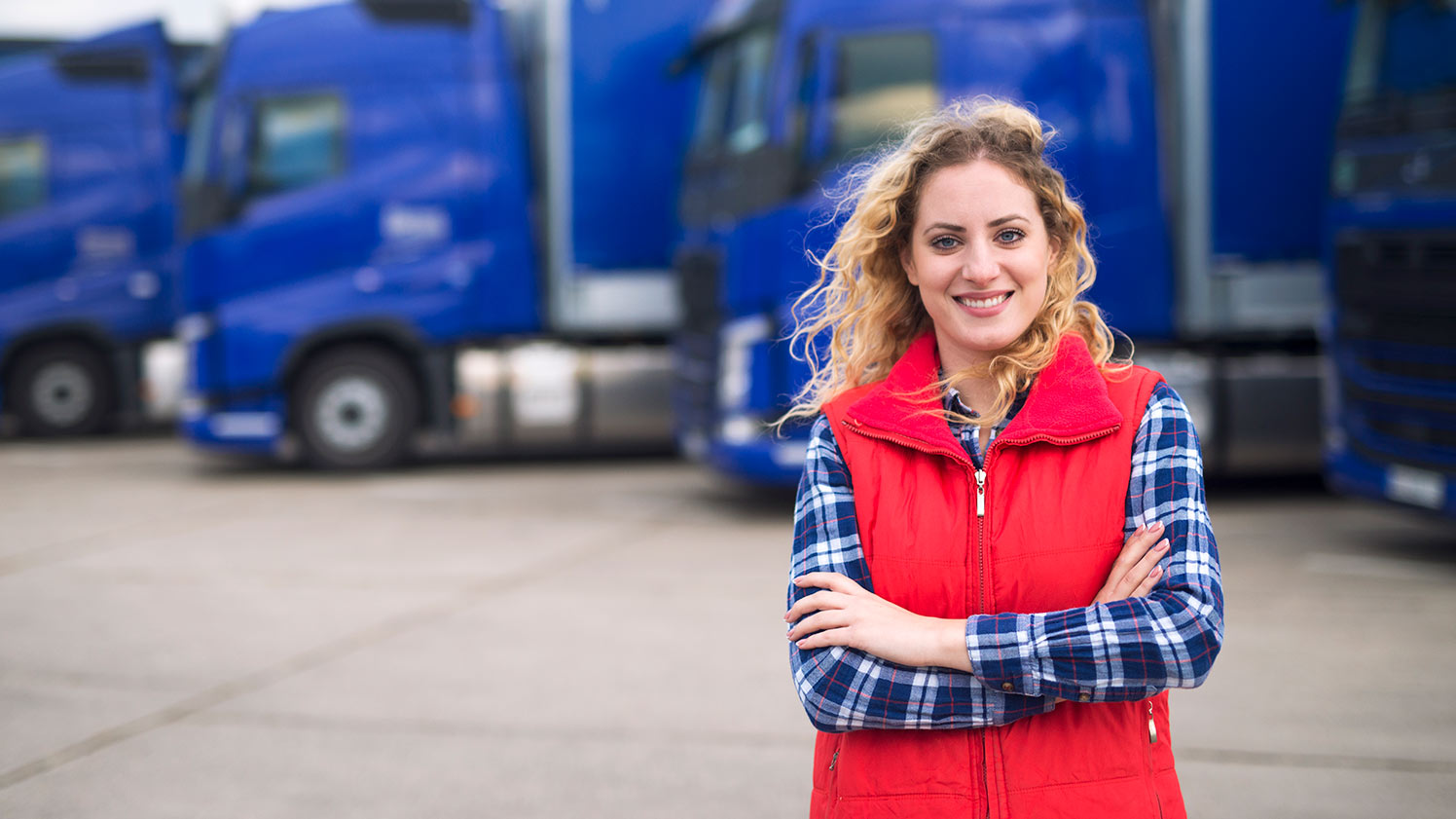 Woman standing in front of vehicles