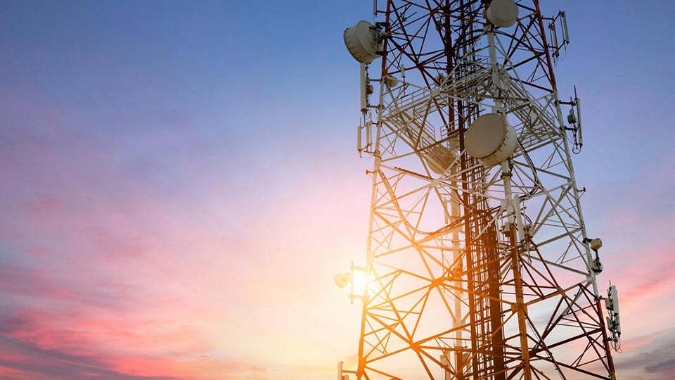 image of a 3g signal tower with a sunset in the background