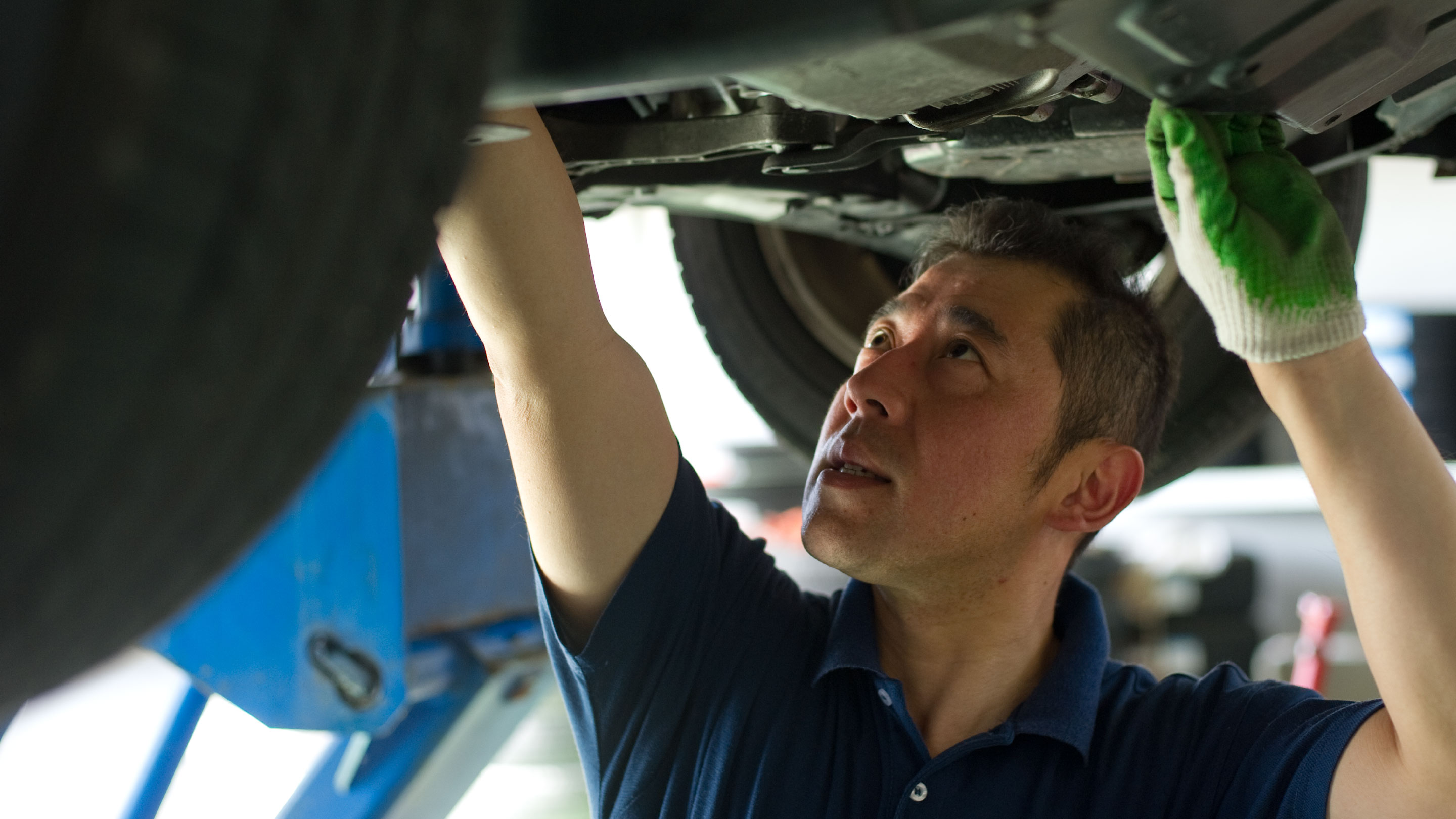 Man performing maintenance in vehicle