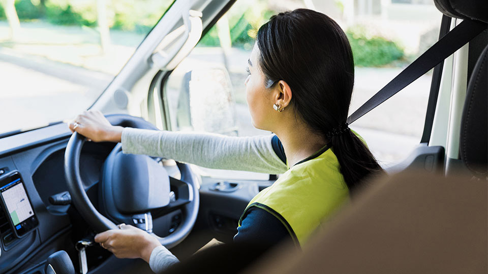 Woman driving a truck in the cab