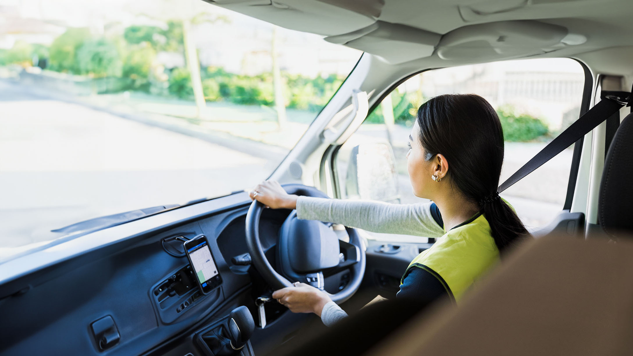 Woman driving a truck in the cab