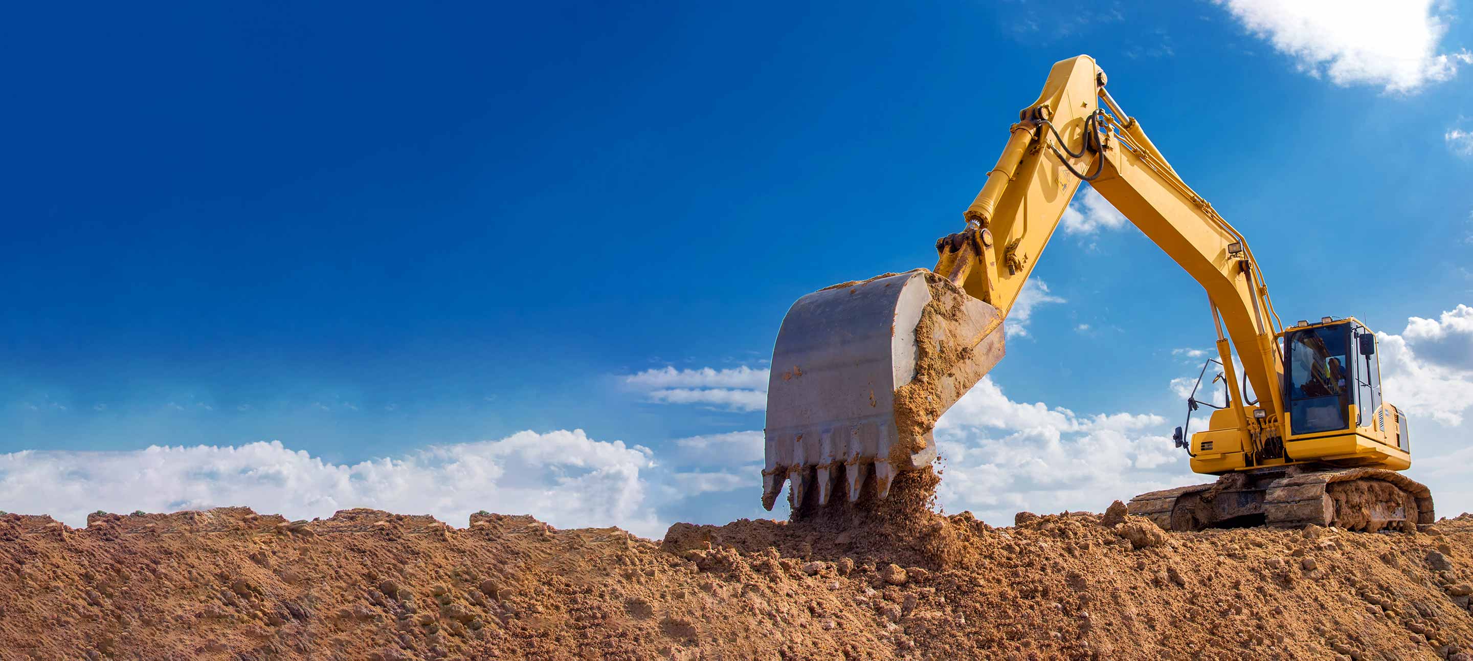Crane digging up dirt at a construction site