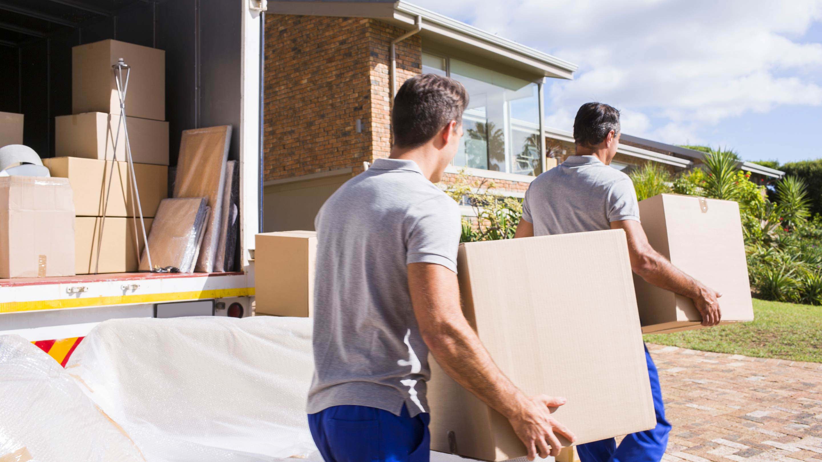 Two men carrying boxes