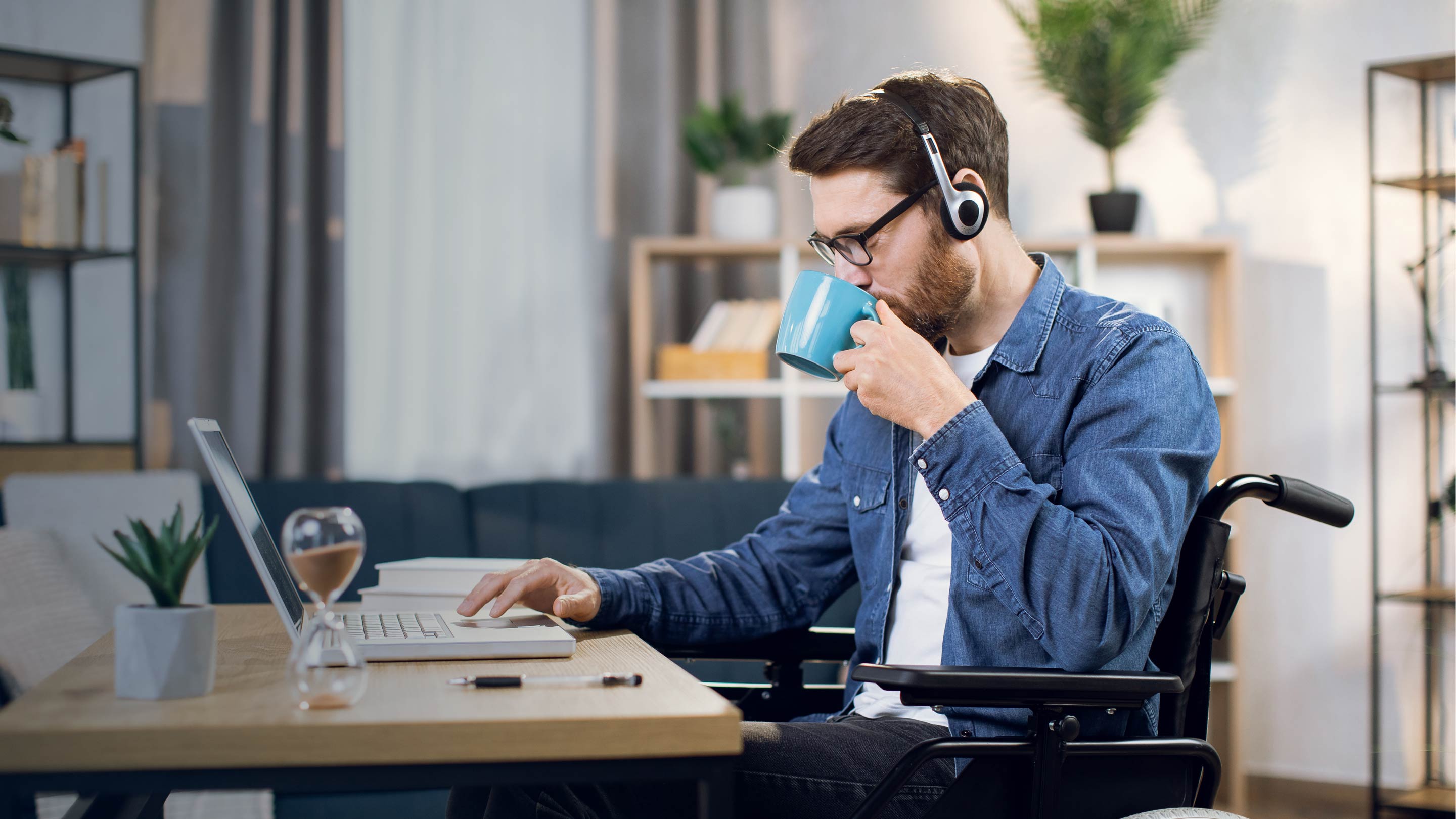 Man working at desk drinking coffee