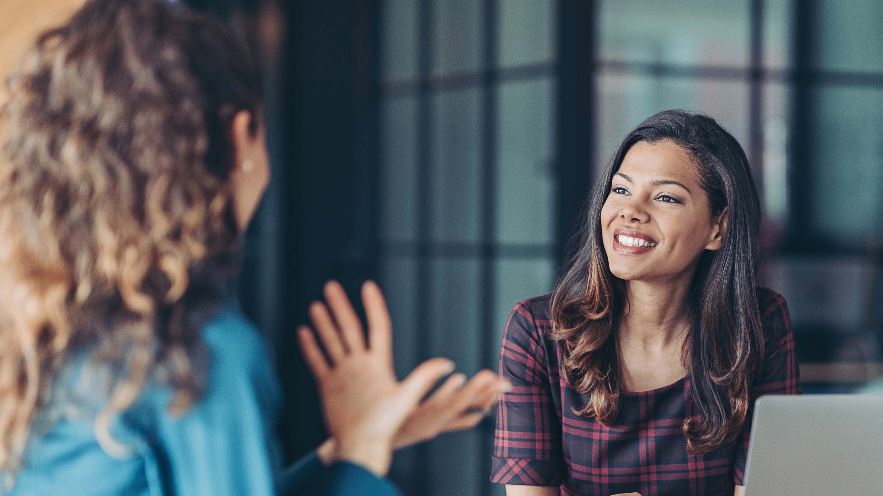 Two people chatting at a table