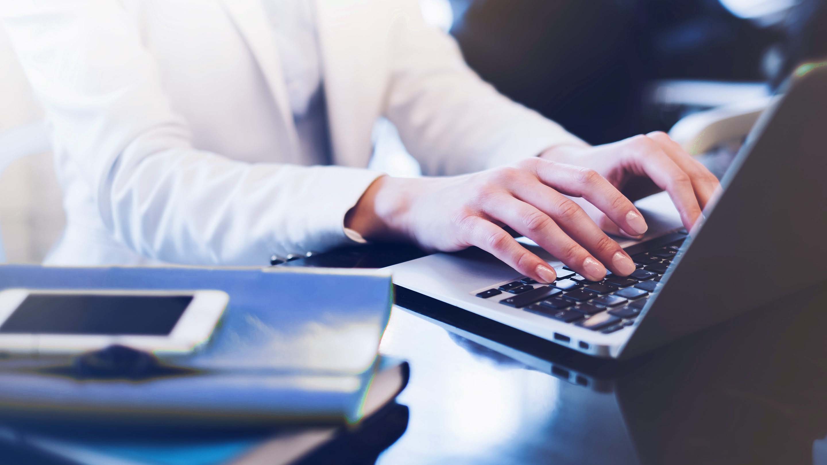 Close up of person typing on laptop