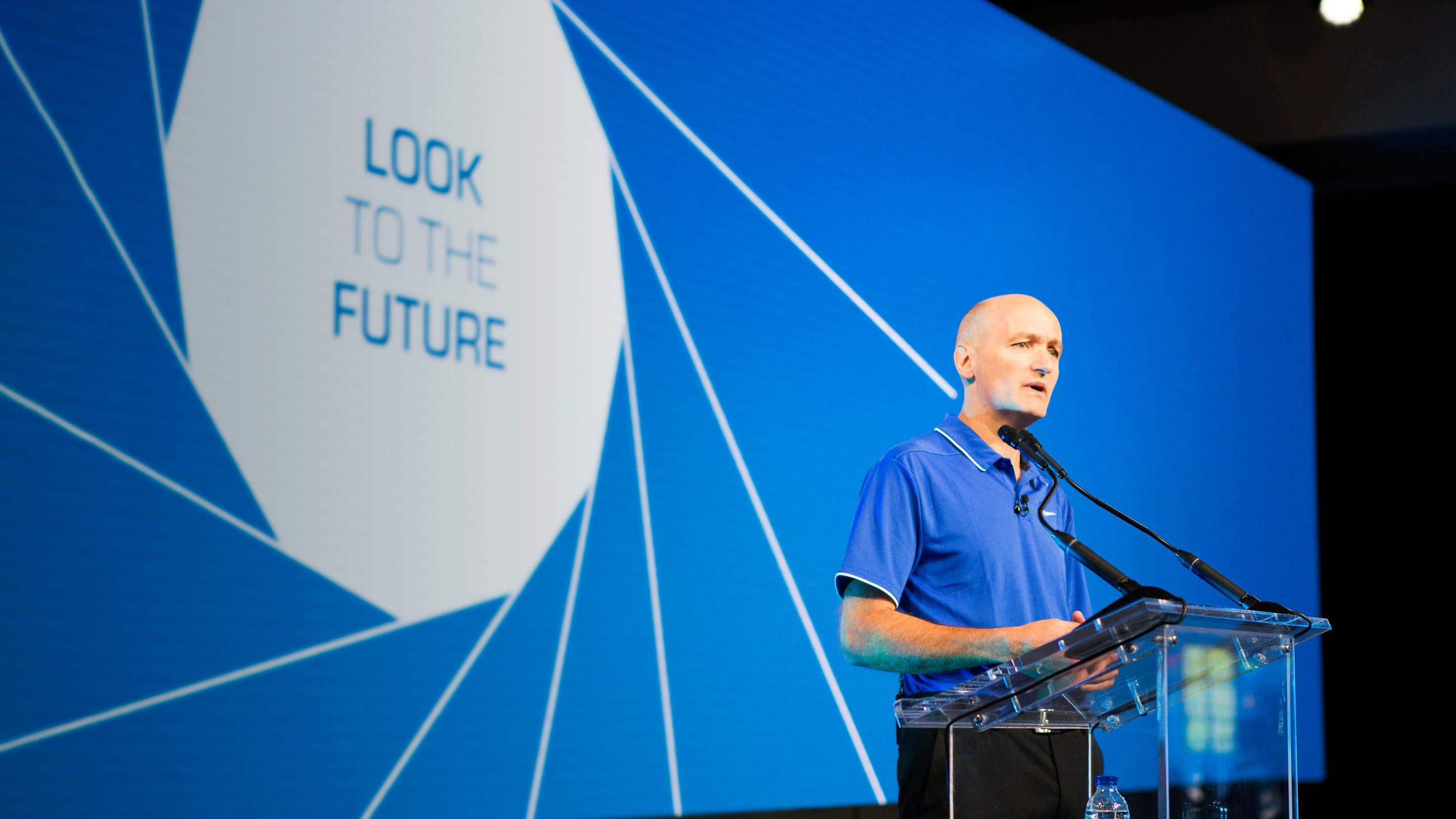 Image of Neil Cawse presenting on stage