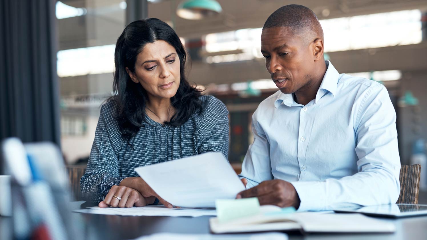 Man and woman looking at paper together