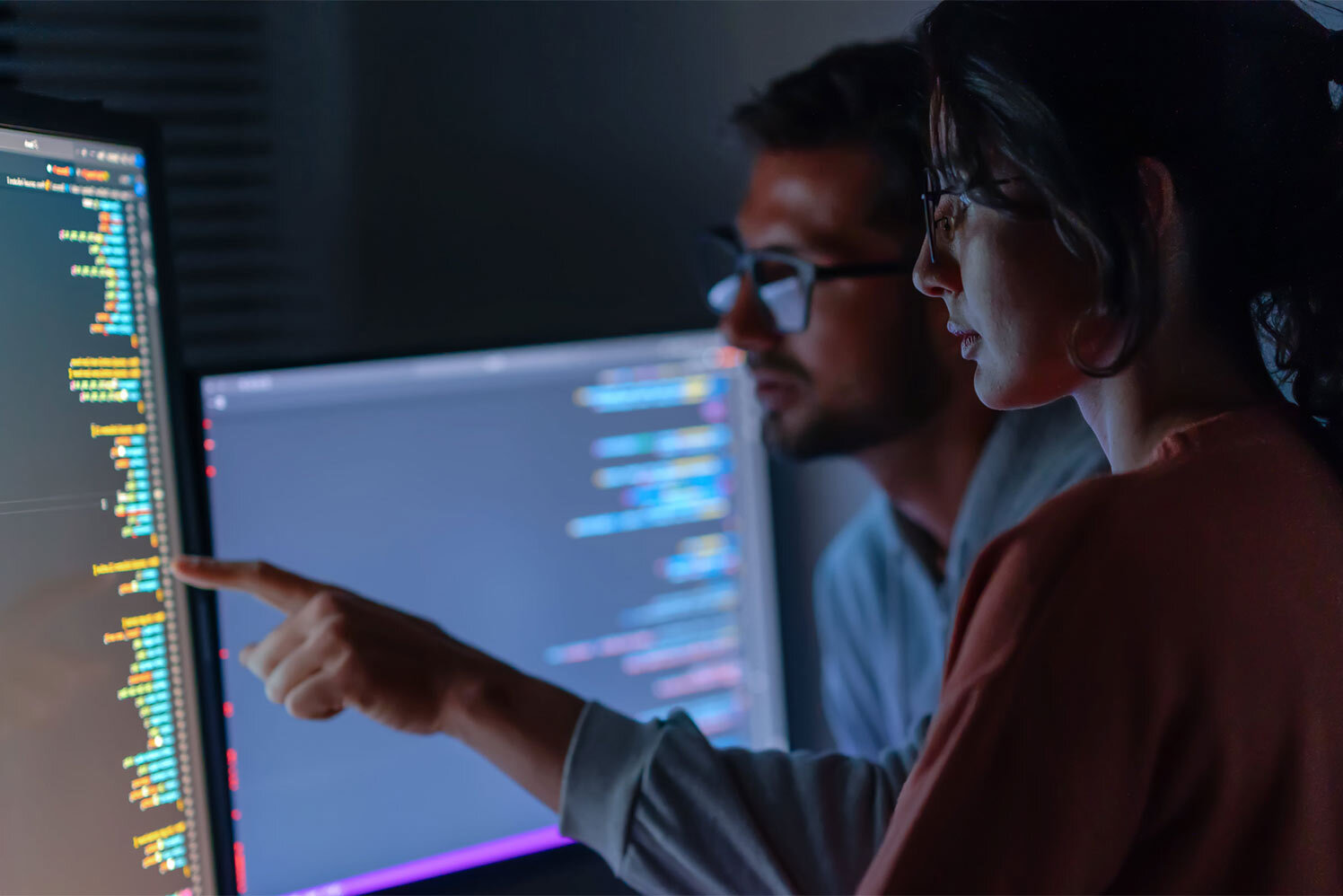 person pointing at computer