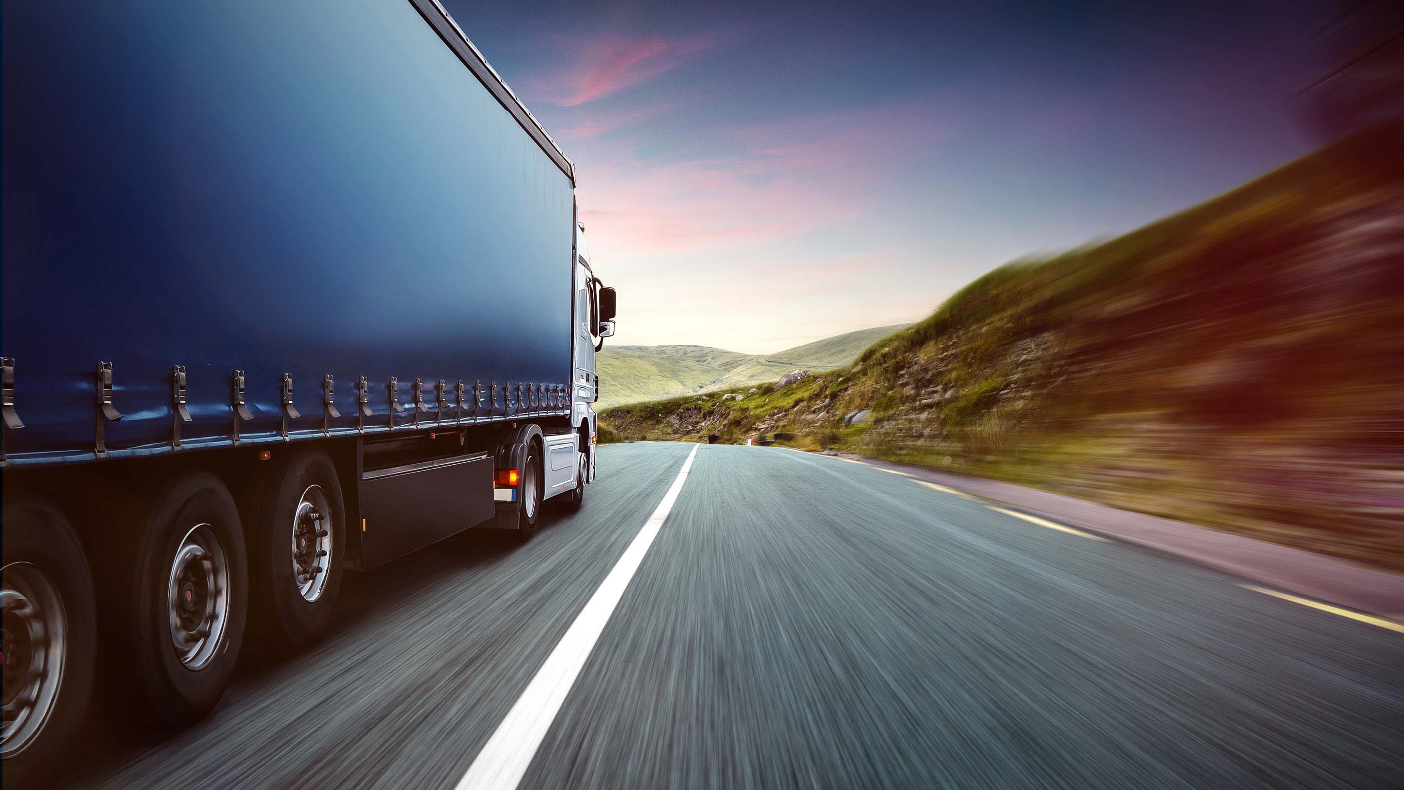 Rear view of truck driving down freeway