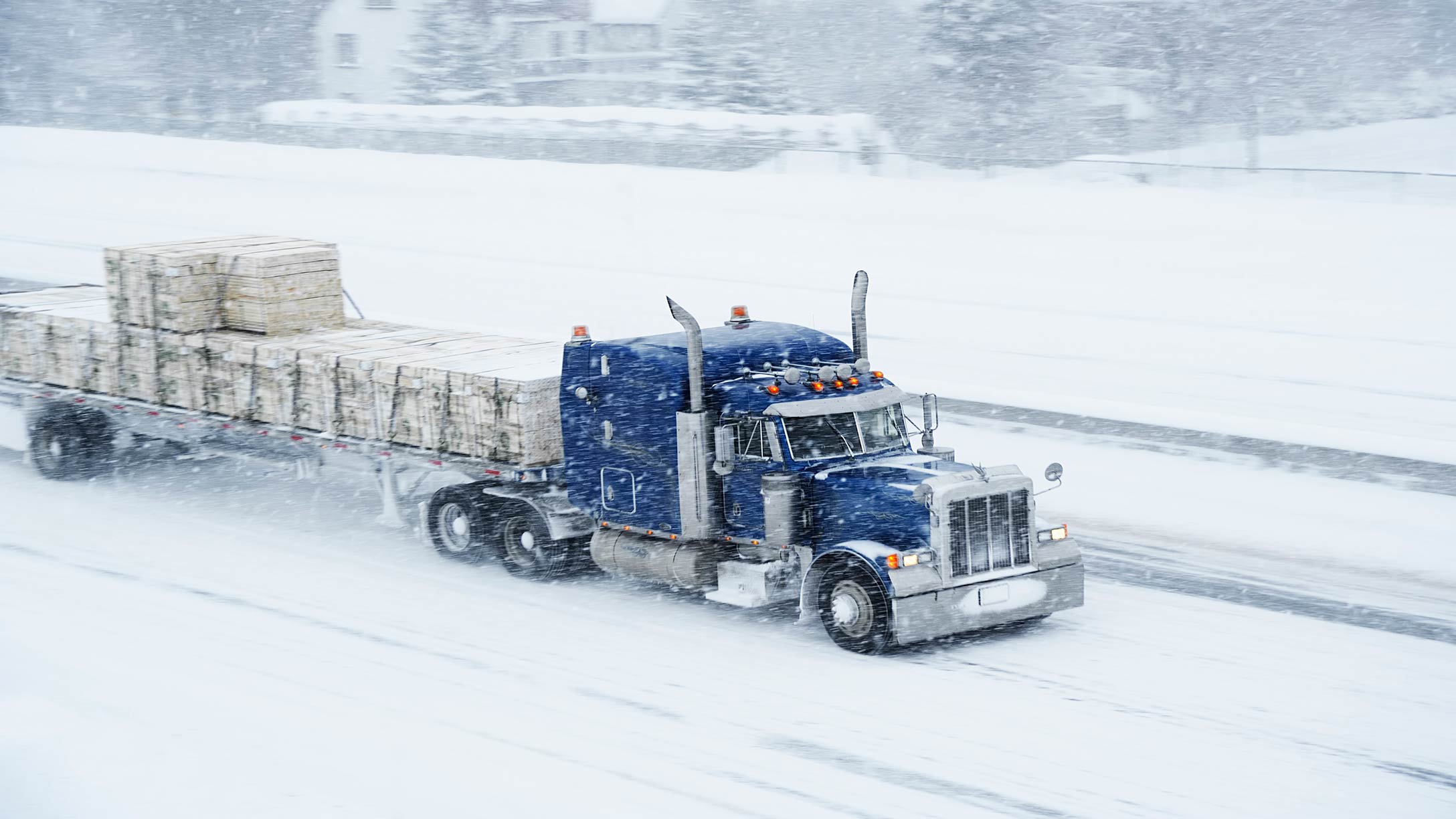 A truck driving through a blizzard 