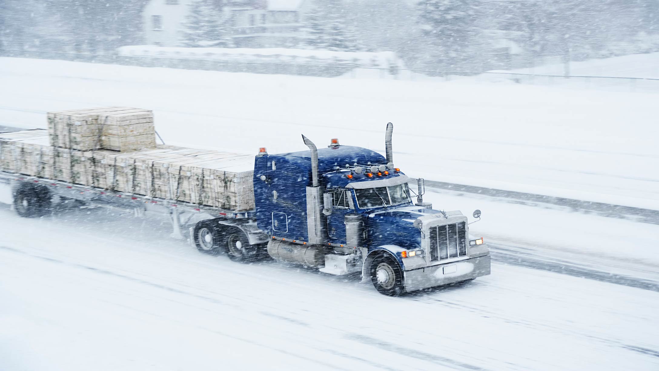 Truck driving on snow covered road