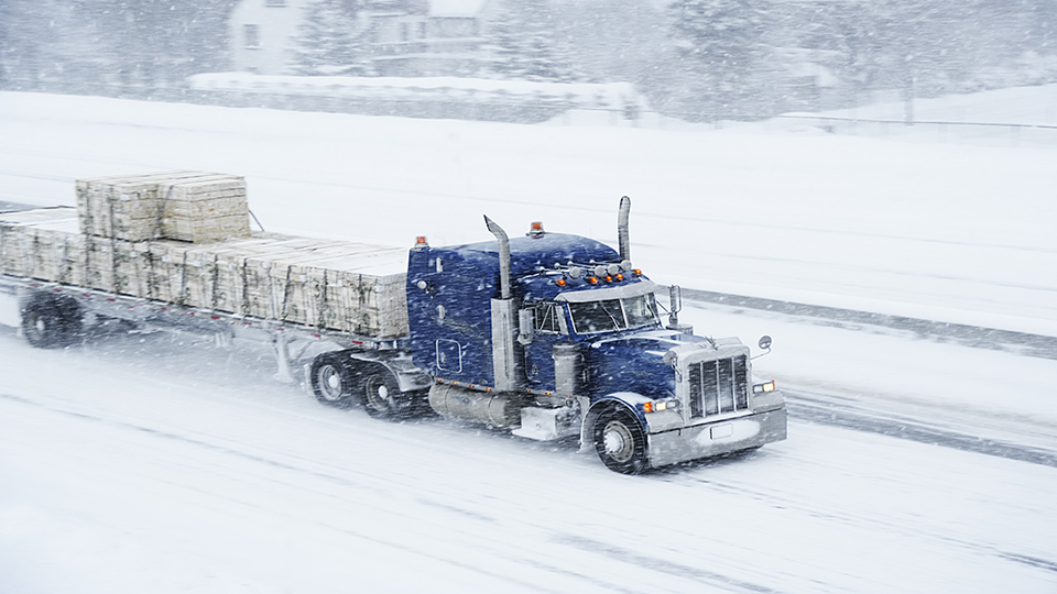 Truck driving on snow covered road